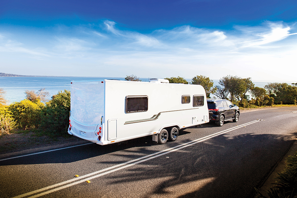 Black SUV towing a caravan