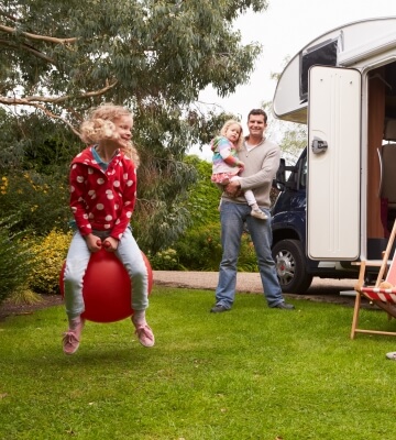 Young family relaxing by their caravan during the Christmas break