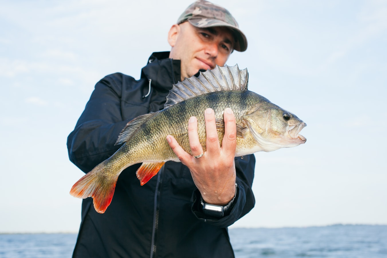 Man holding a fish caught deep-sea fishing