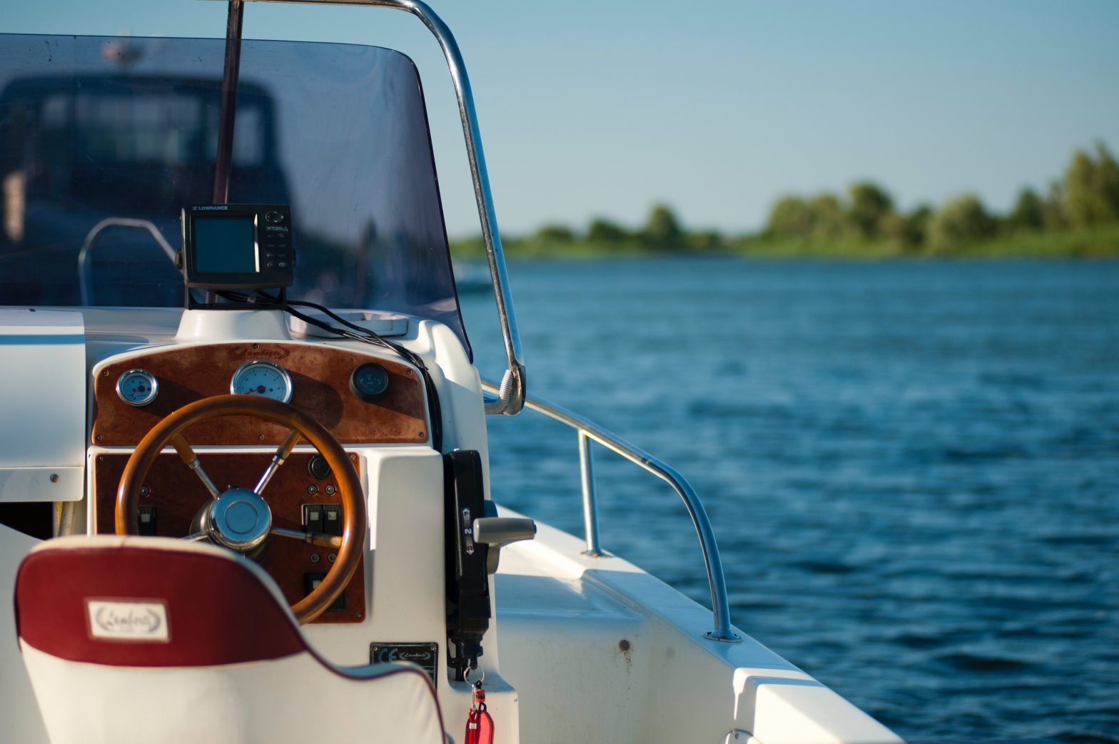 Brown and white boat sitting on the water