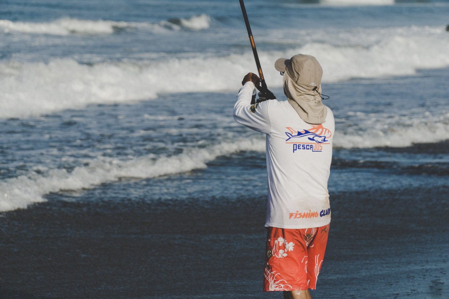 Man standing on the beach fishing