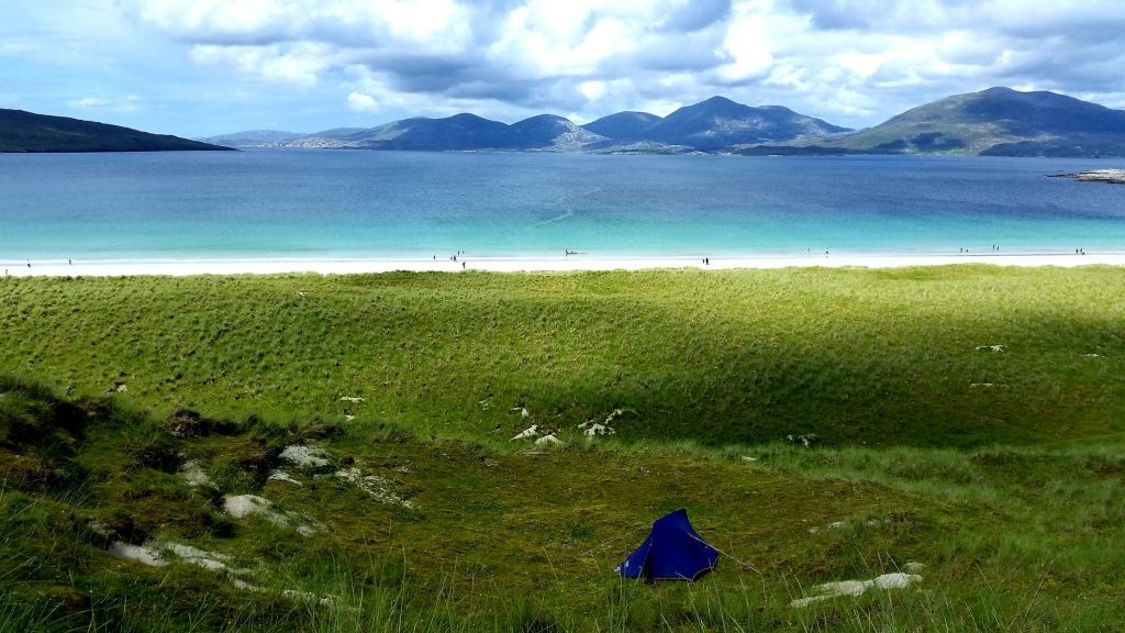 View of the beach from a grassy knoll