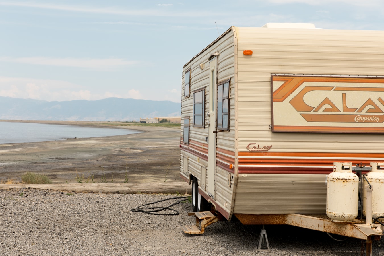 Red and white Calay Companion caravan parked at a powered site