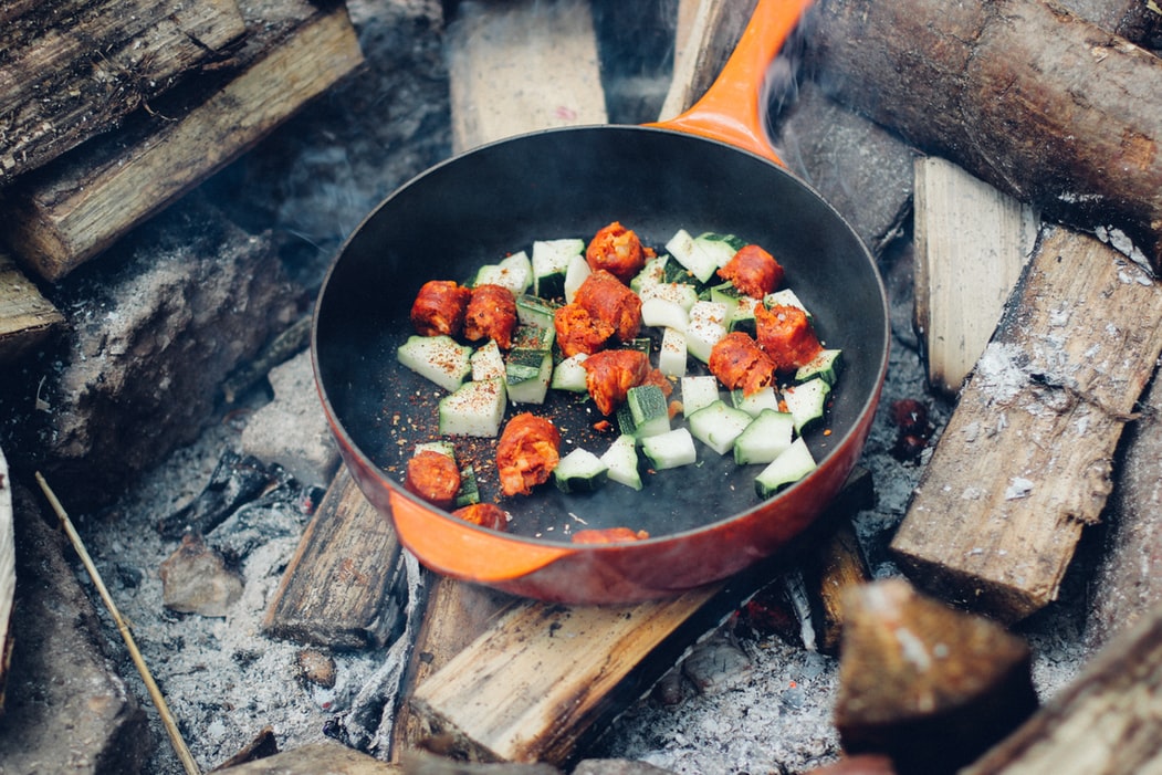 Cooking food on the coals of a campfire