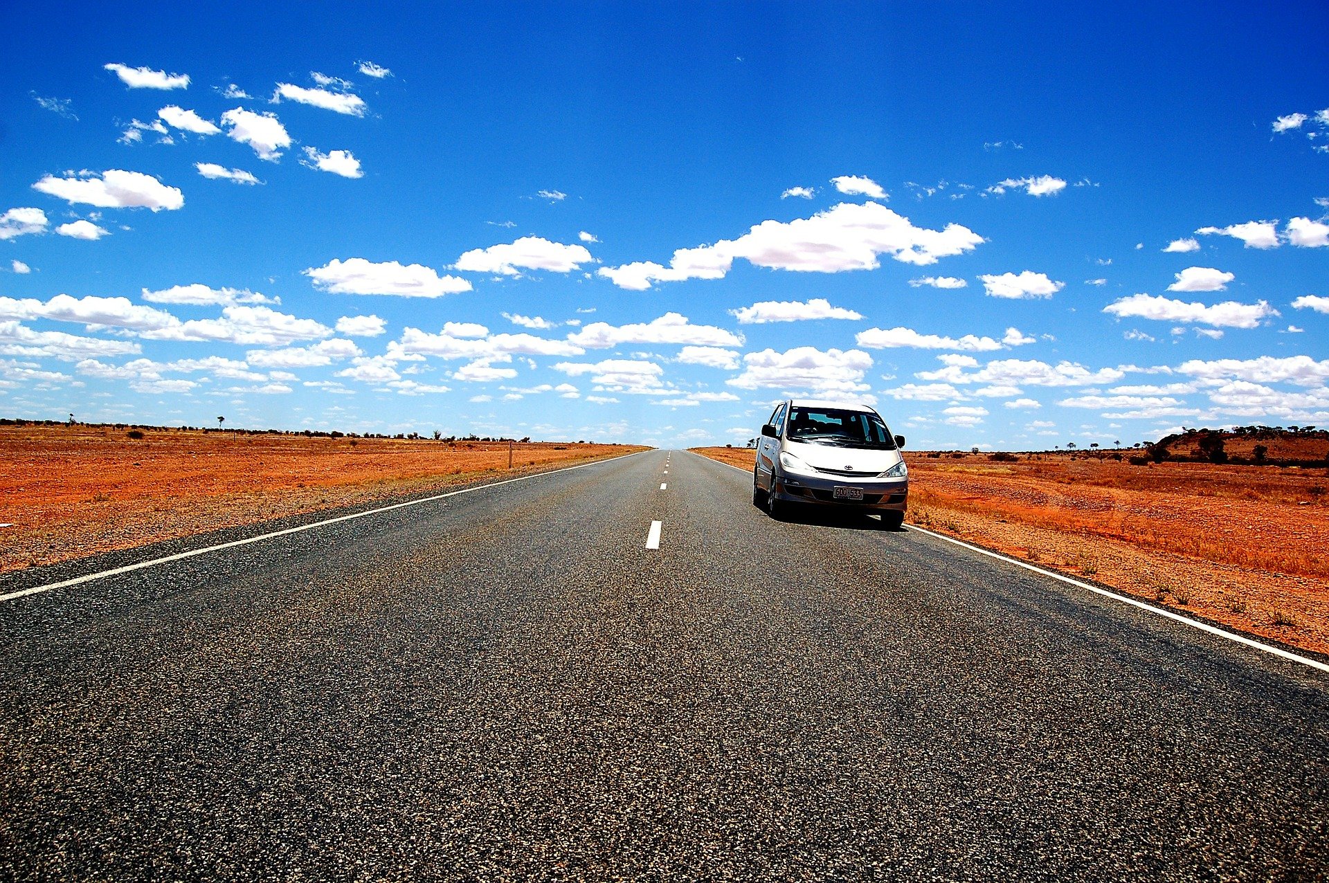 White vehicle driving in the outback