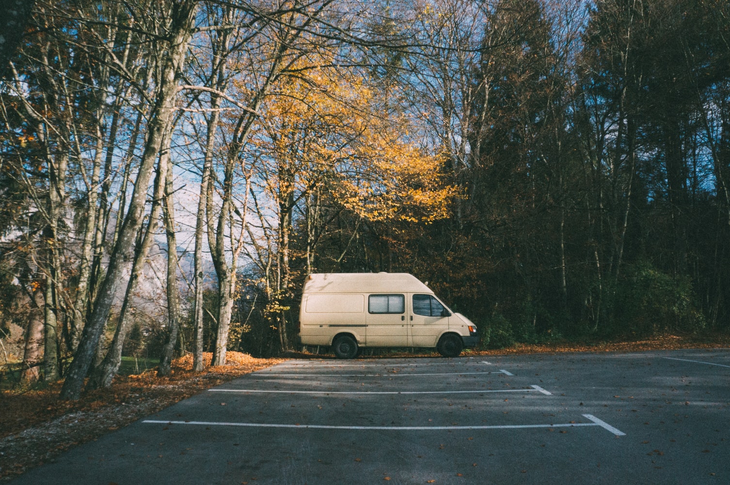 Single camper van parked in an empty parking lot