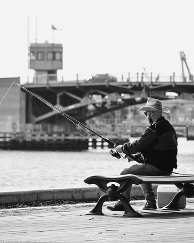 solo man fishing from a pier