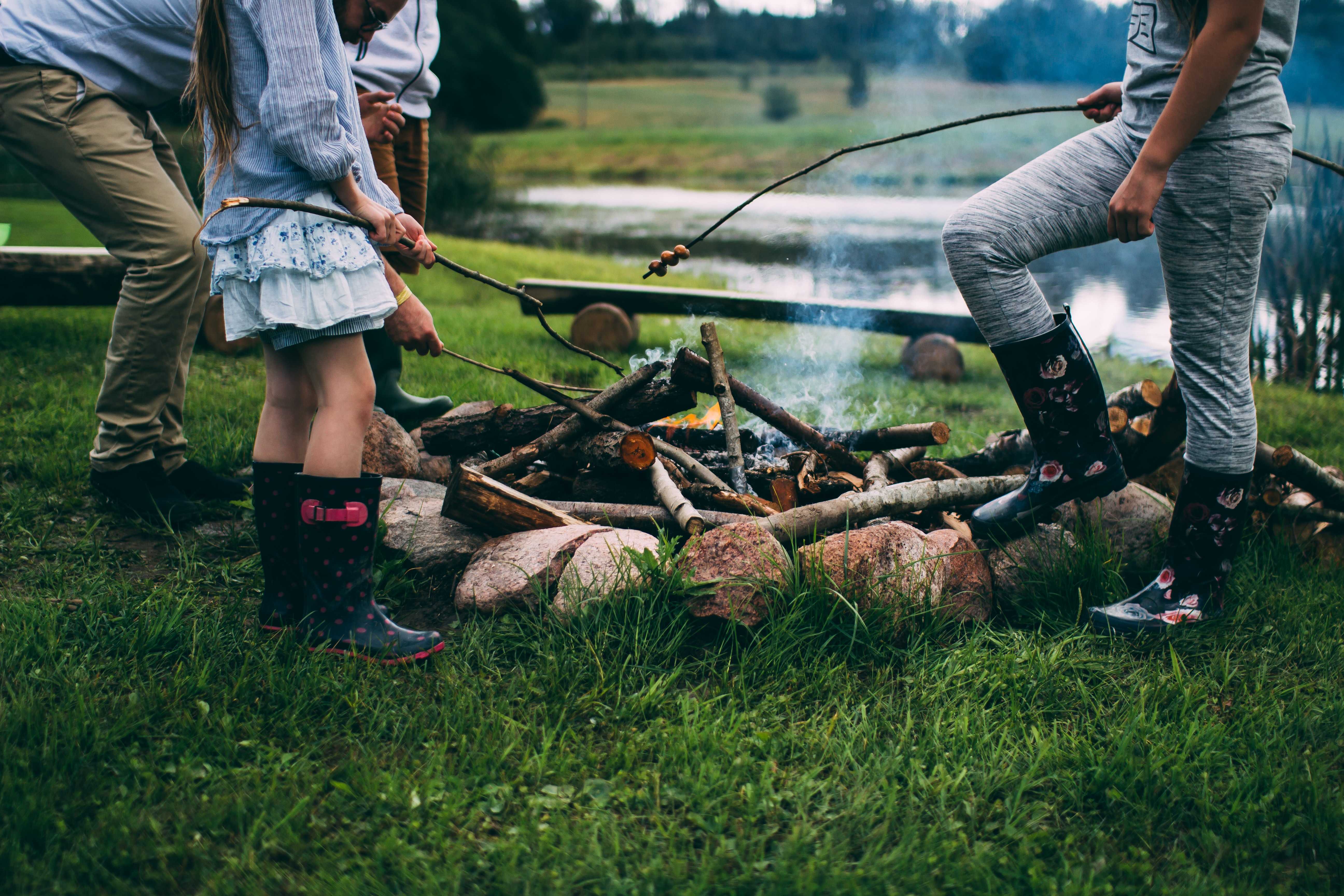 Family gathered around small backyard campfire