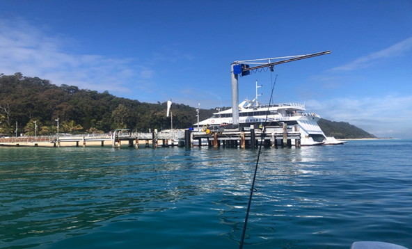 Throwing a line off the back of the boat to catch a massive Kingfish.